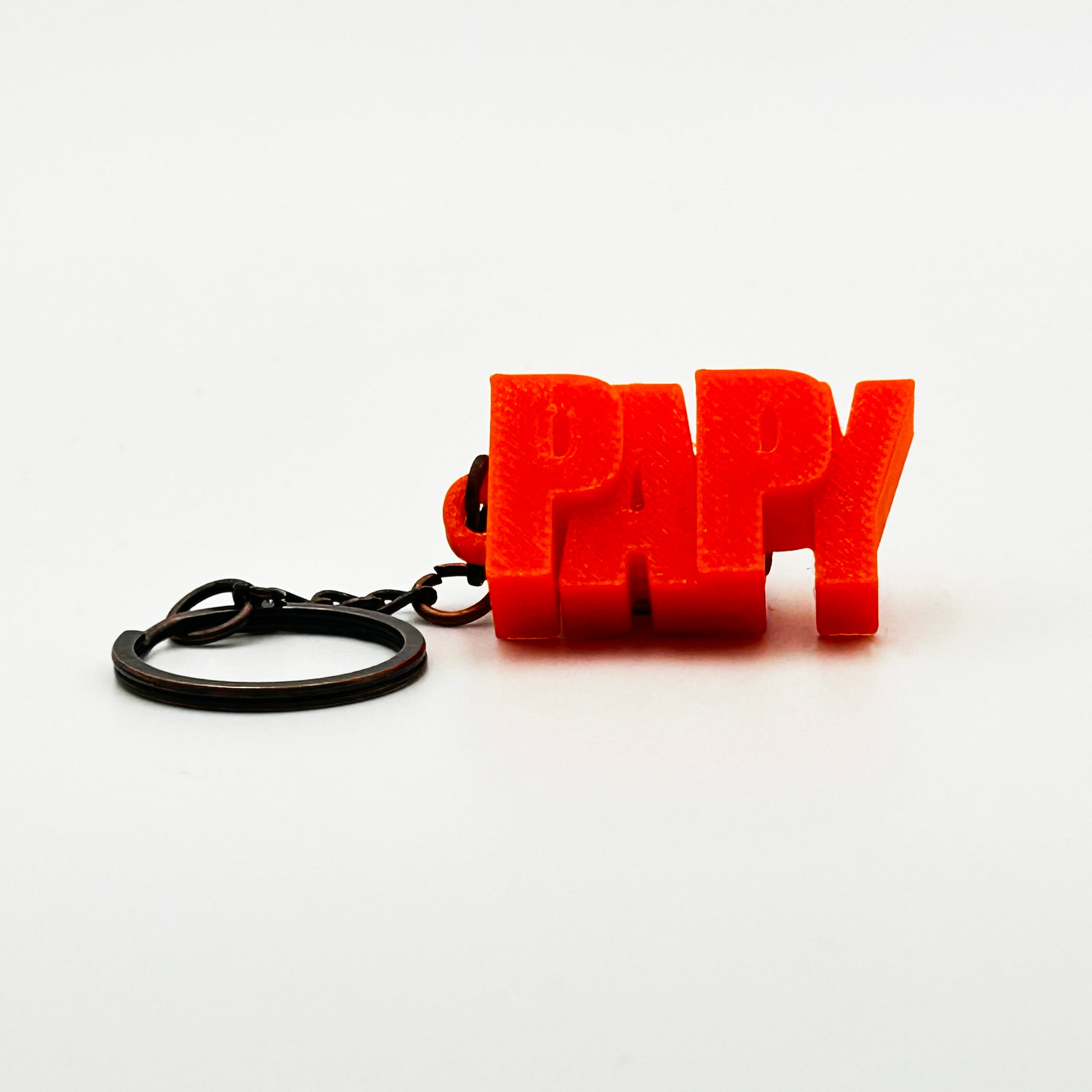 Porte-clés à message « Papy », imprimé en 3D, présenté dans un tube à essai.