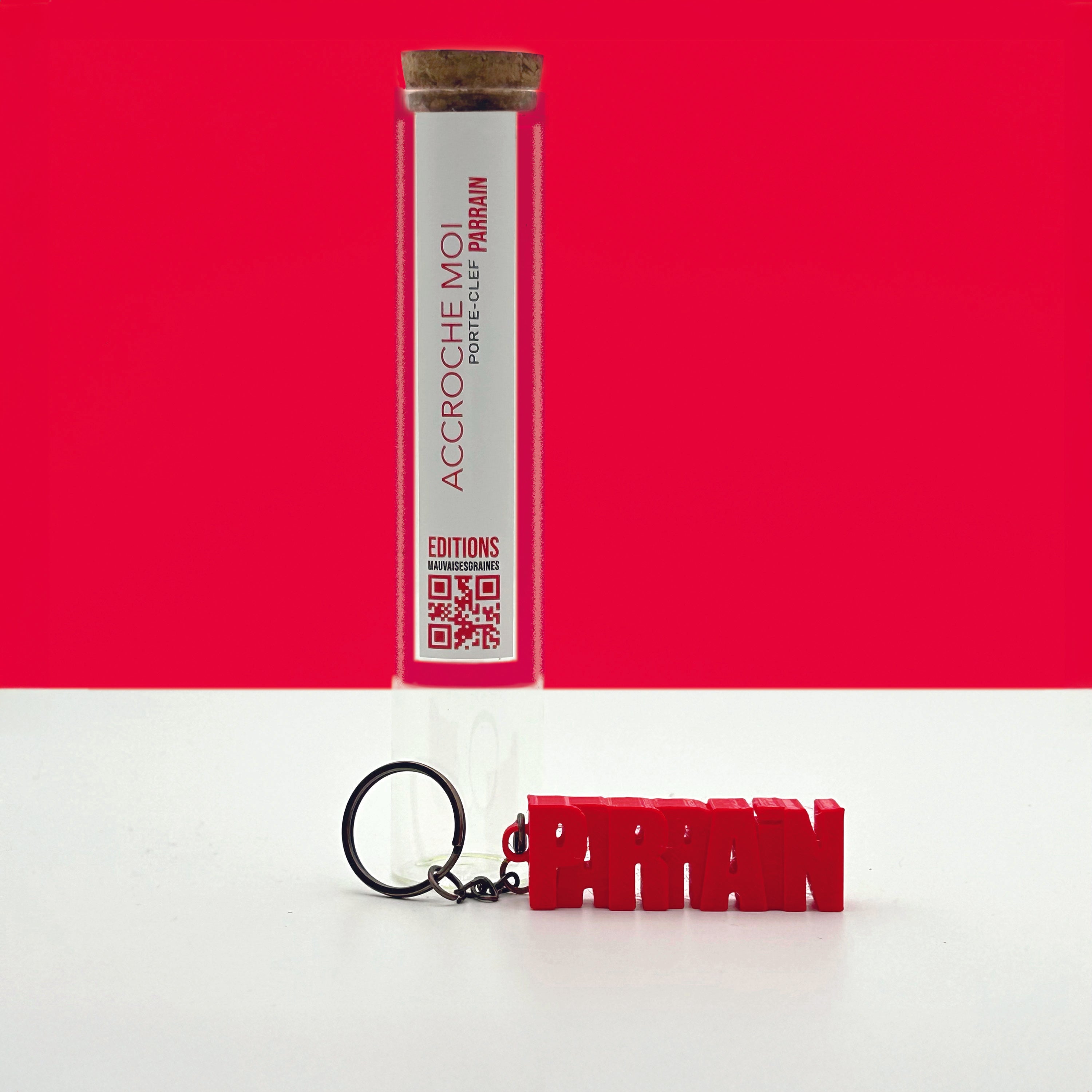 Porte-clés à message «Parrain », imprimé en 3D, présenté dans un tube à essai.