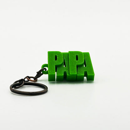 Porte-clés à message « PAPA », imprimé en 3D, présenté dans un tube à essai.